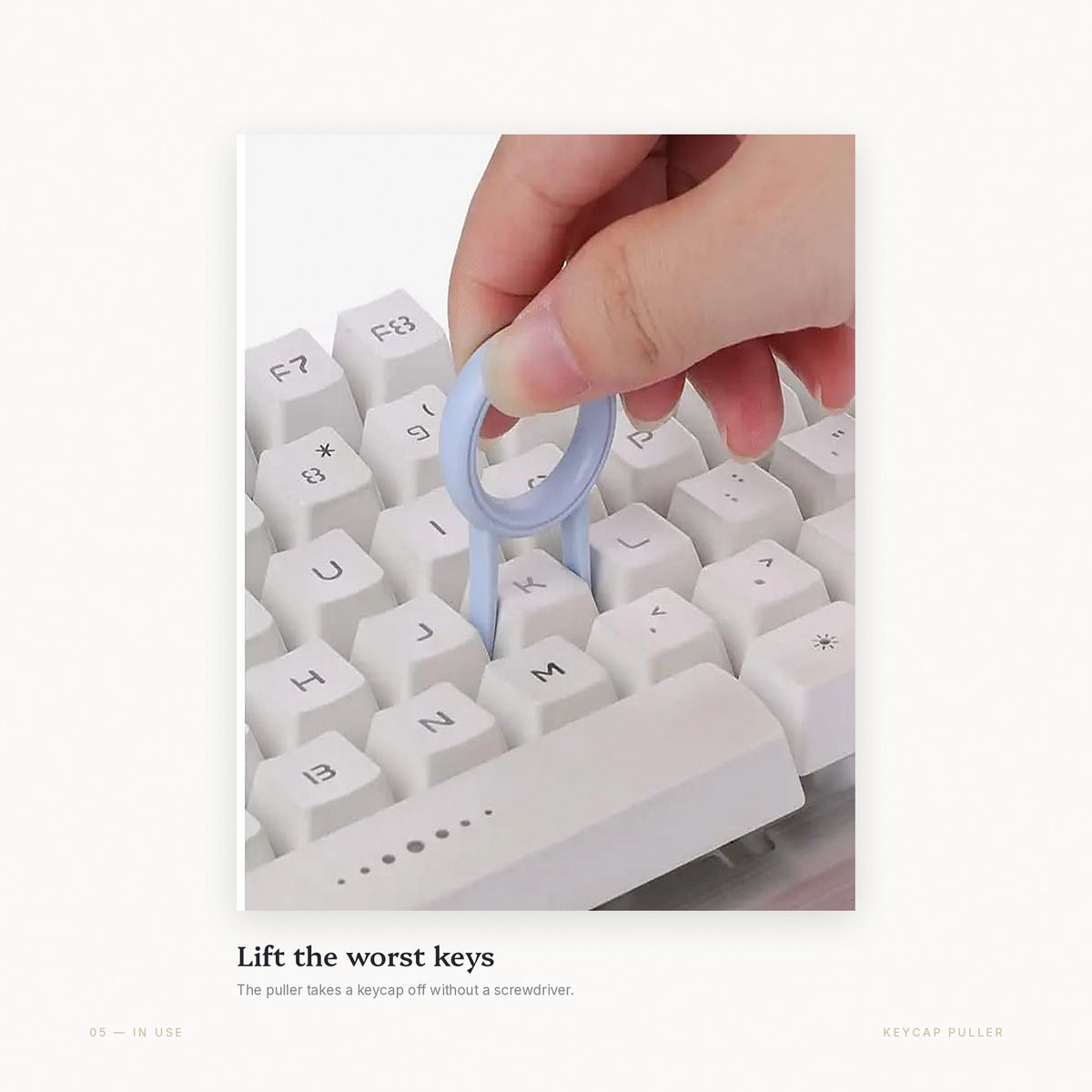 The keycap puller lifting a keycap off a mechanical keyboard